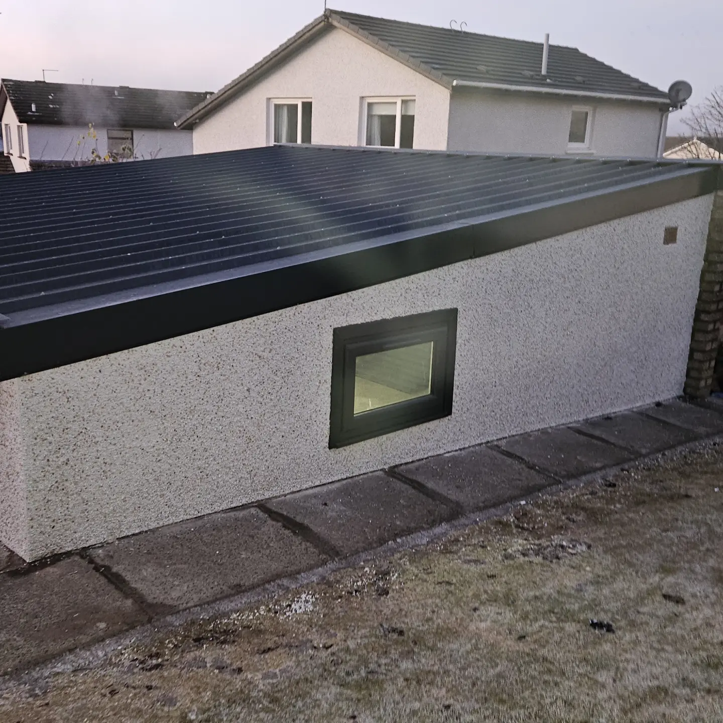 Garage refurbished with a new roof, roughcast walls, an electric door and a new window