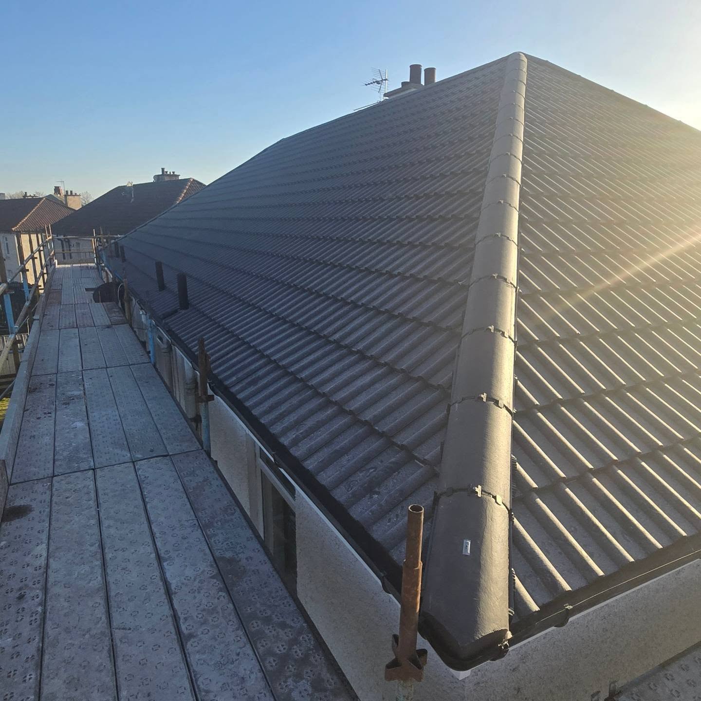 Roof renewal on a four-in-a-block with the chimney removed and fresh roughcast